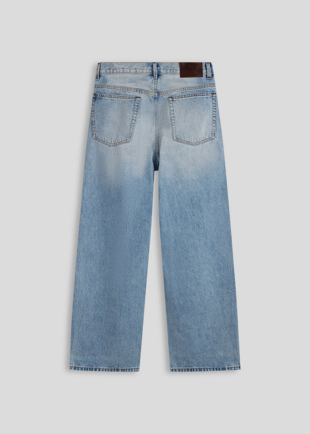 La Corsia Vintage Wash Relaxed Denim in light blue, flat lay on a plain background