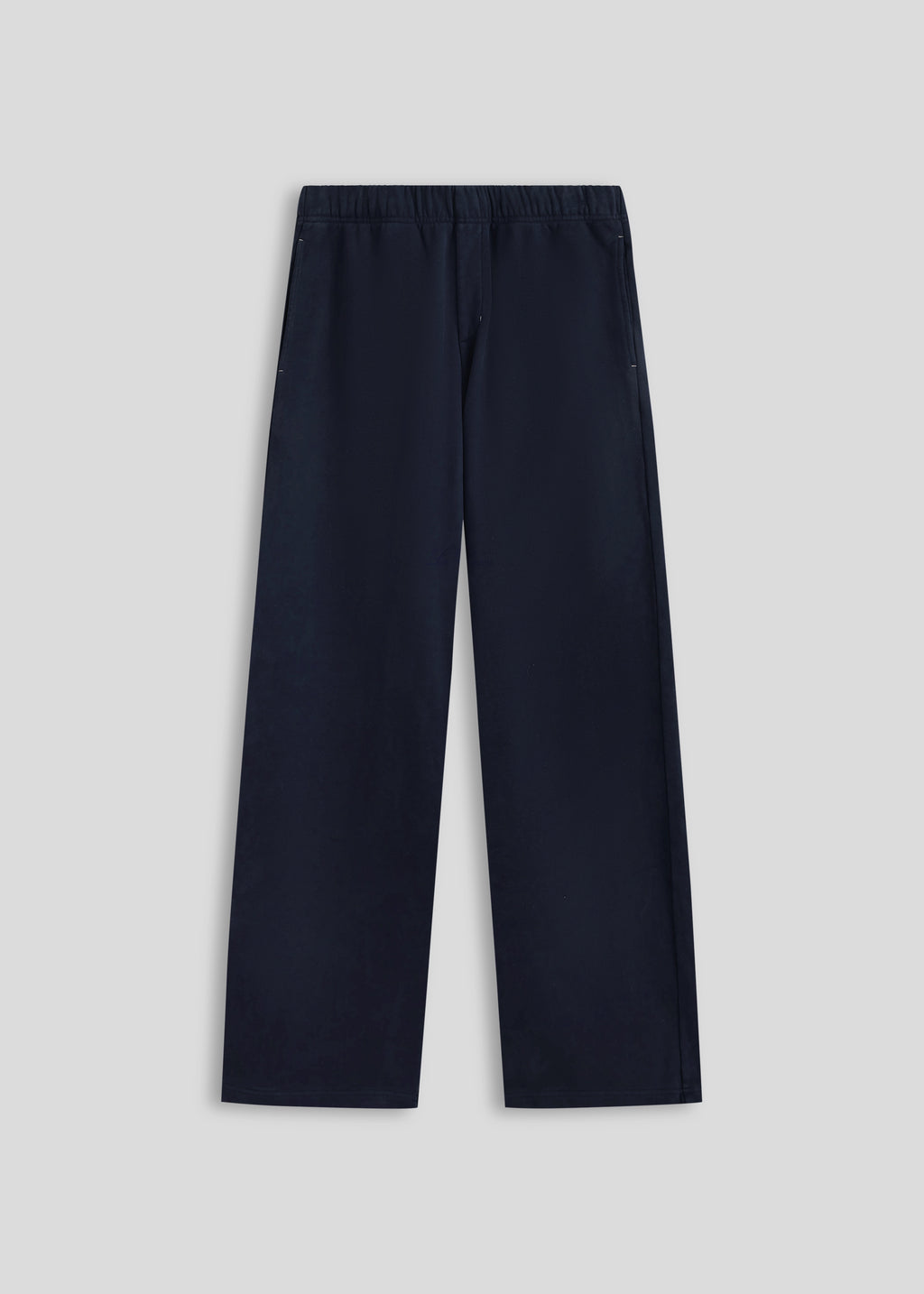 La Corsia Oversized Track Pant in washed navy, flat lay on a plain background