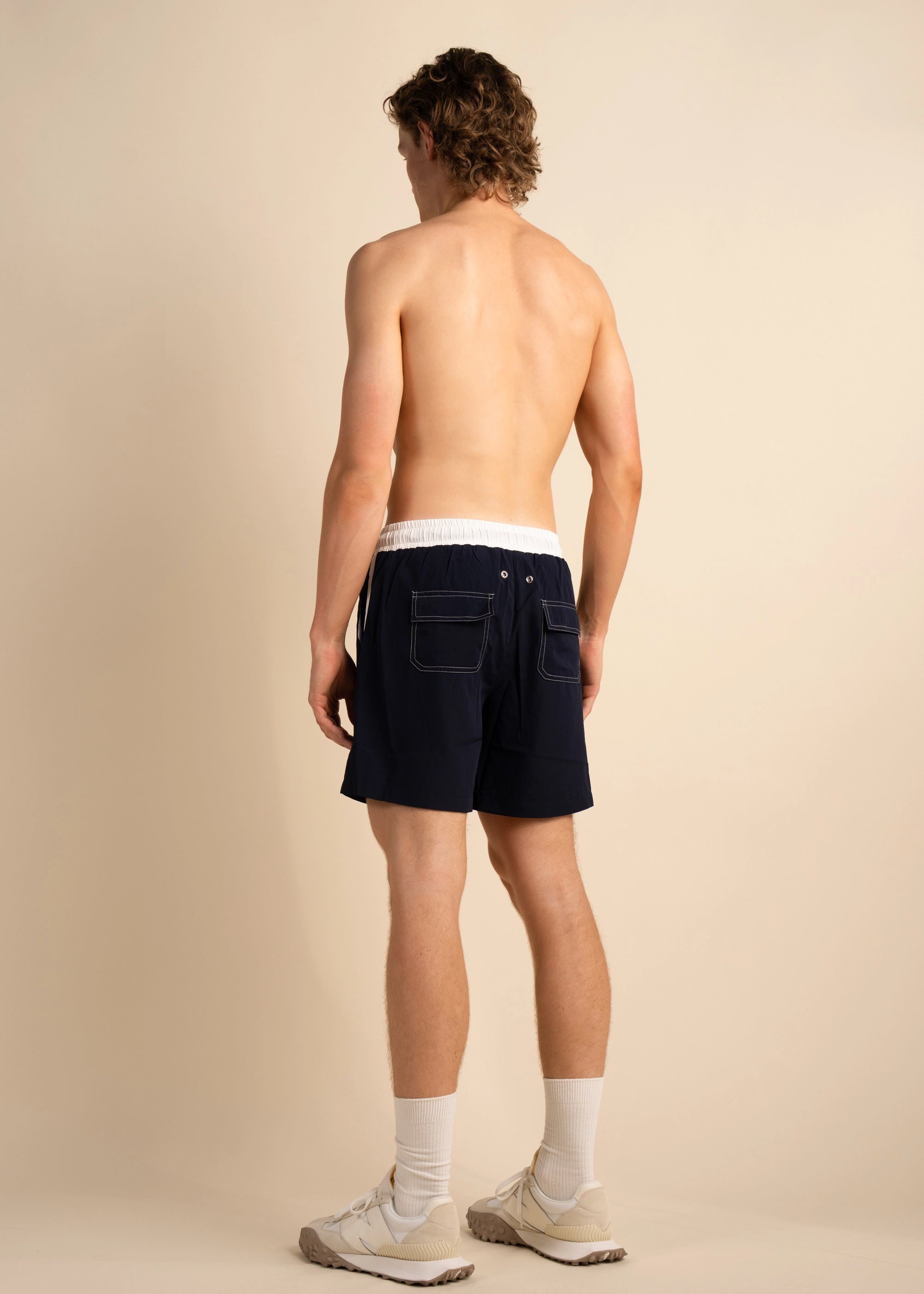 Detailed back pocket contrast stitching navy and white. Silver drainage grommets. Navy Swim Short La Corsia