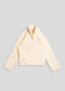 La Corsia Wide Sleeve Cable Knit sweater in cream, crafted from heavyweight cotton with a quarter zip, funnel neck, and sculpted oversized silhouette.