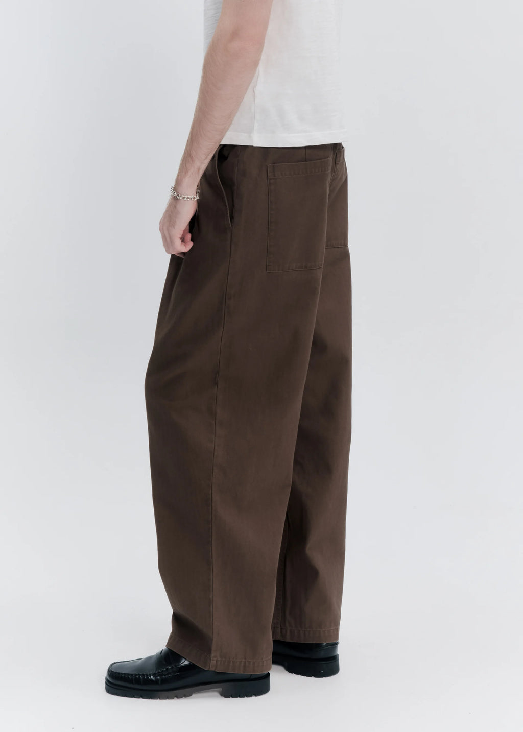Brown wide-leg pants worn by a person on a white background